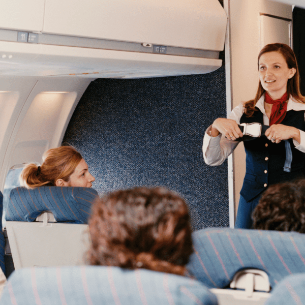 cabin crew explaining safety procedures to the passengers